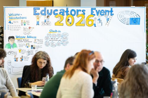 Teilnehmende Lehrkräfte sitzen an Tischen vor einem großen Whiteboard mit dem Titel „Educators Event 2026“ | Sabine Verheyen